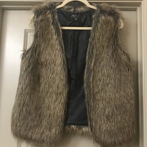 Barely worn faux fur vest with leather belt.